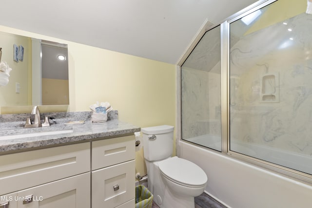 full bathroom with vanity, enclosed tub / shower combo, and toilet