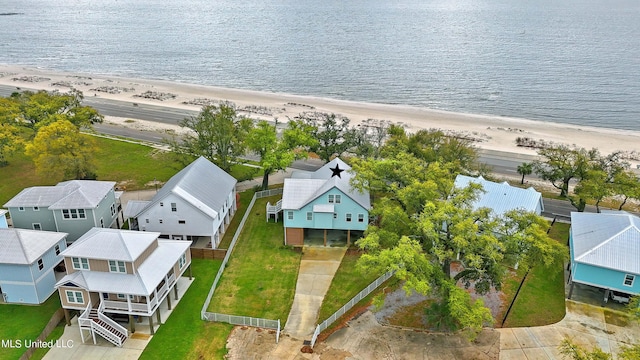 birds eye view of property featuring a water view and a beach view