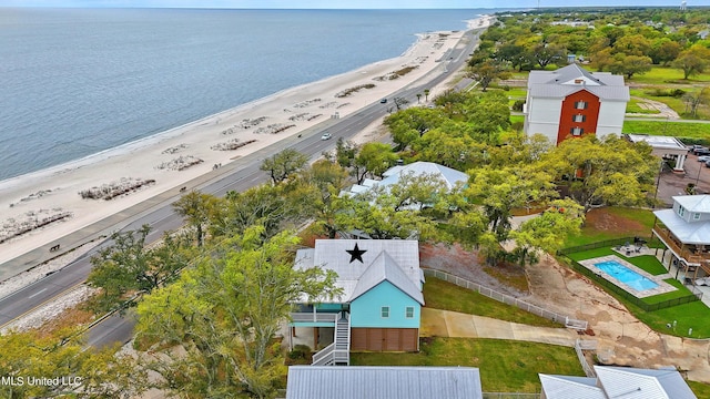 drone / aerial view featuring a water view and a view of the beach