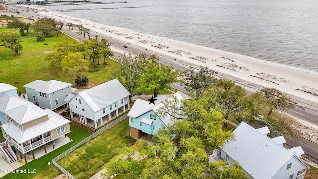 drone / aerial view with a water view and a beach view