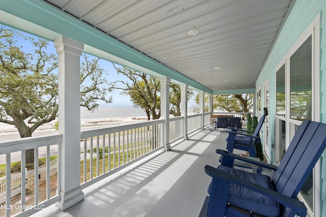 view of patio with a water view