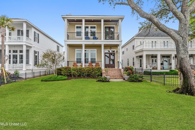 back of property featuring a yard and a balcony