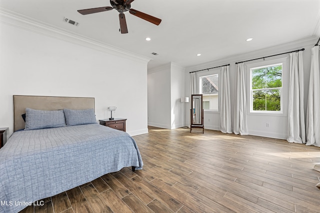 bedroom with hardwood / wood-style flooring, ceiling fan, and ornamental molding