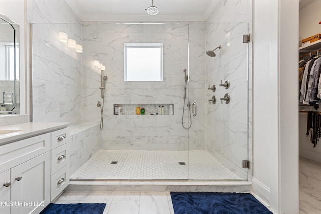 bathroom featuring crown molding, vanity, and a shower with shower door