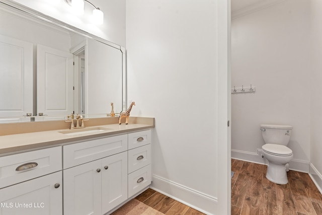 bathroom featuring vanity, toilet, and hardwood / wood-style floors