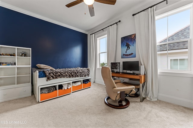 carpeted bedroom with crown molding and ceiling fan