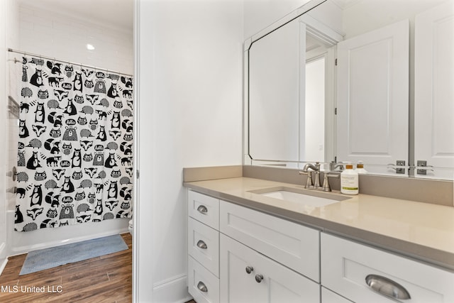 bathroom featuring wood-type flooring, shower / bathtub combination with curtain, and vanity