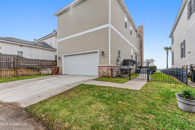 view of home's exterior with a garage and a yard