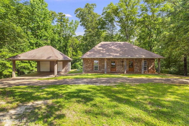500 E Dewey Camp Dr, Florence, MS 39073 - view of front of home featuring a front lawn, an outbuilding, a garage, and a porch