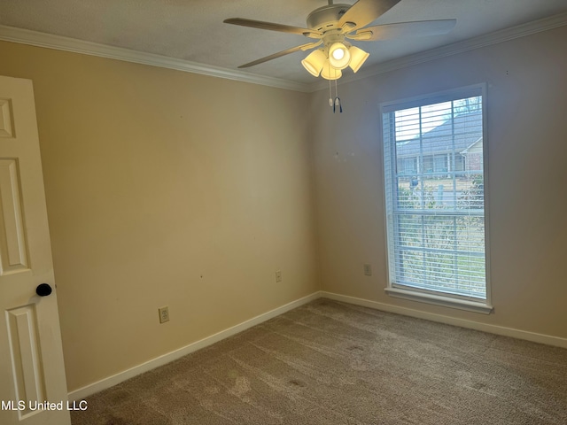 carpeted empty room with baseboards, ornamental molding, and ceiling fan