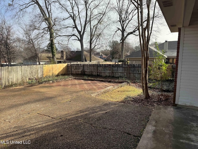 view of yard featuring a fenced backyard and a patio