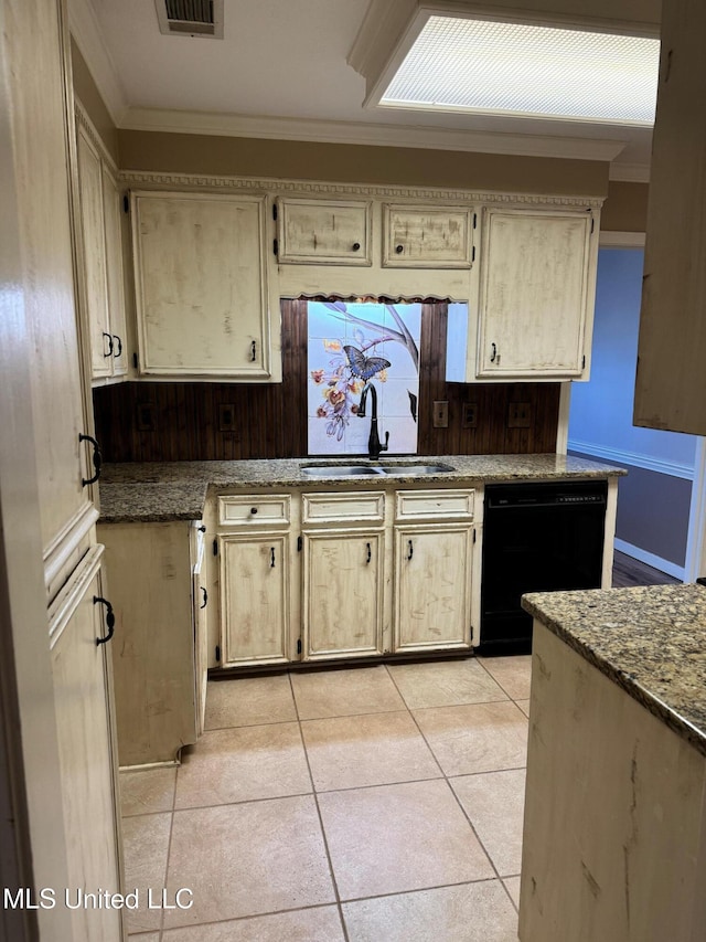 kitchen featuring light tile patterned flooring, a sink, visible vents, black dishwasher, and ornamental molding