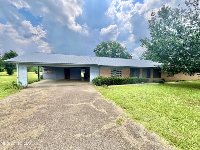 ranch-style house featuring driveway, an attached carport, a front yard, and brick siding