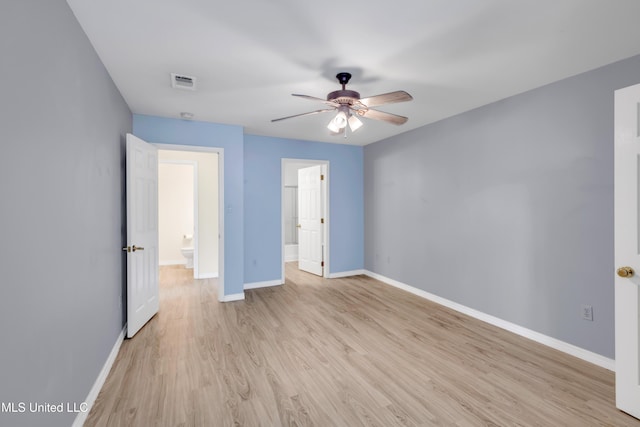 unfurnished bedroom with baseboards and light wood-style flooring