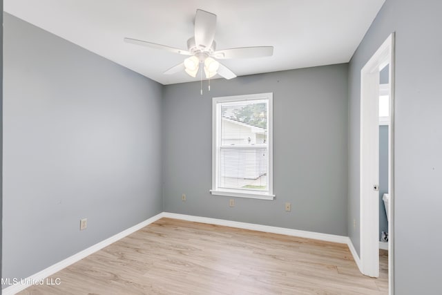 empty room with ceiling fan, baseboards, and light wood-type flooring