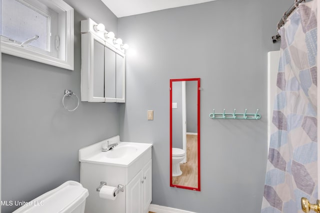 bathroom featuring vanity and toilet