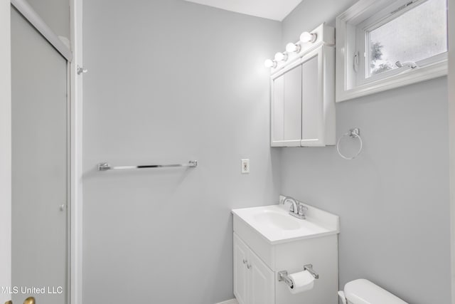 bathroom featuring vanity and toilet
