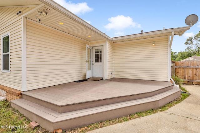 exterior space featuring a wooden deck and fence