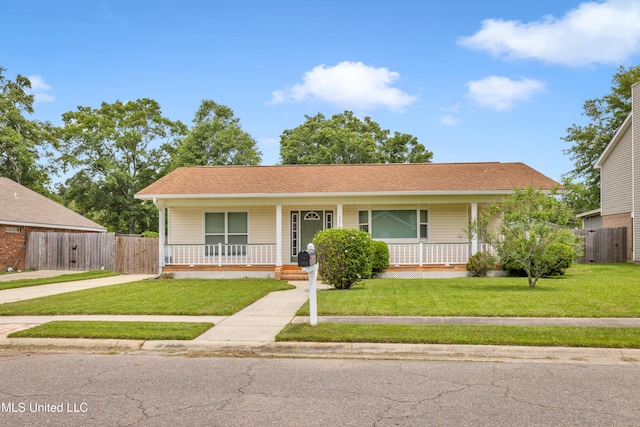 single story home with fence, covered porch, and a front yard