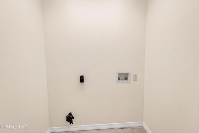 washroom featuring laundry area, hookup for a washing machine, baseboards, and light wood finished floors