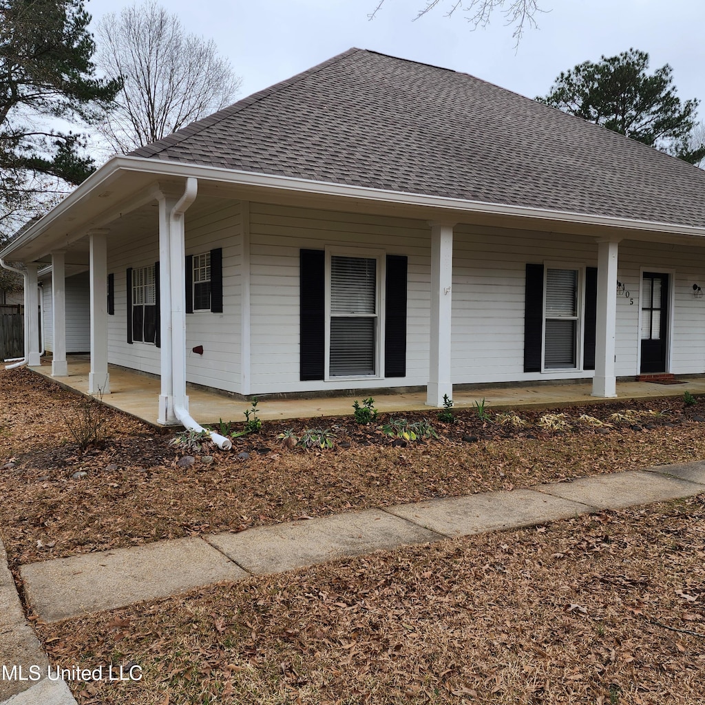 view of front of home featuring a porch and roof with shingles