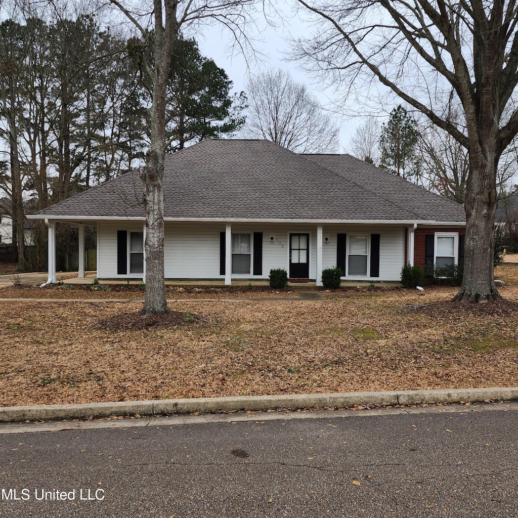 ranch-style home featuring a porch and a shingled roof