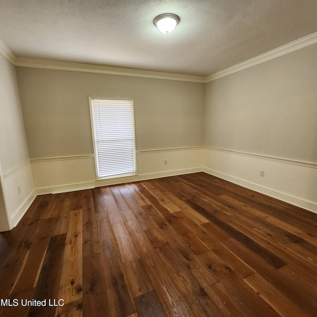 empty room featuring ornamental molding, baseboards, and dark wood-style flooring