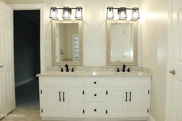 bathroom featuring tile patterned flooring and vanity