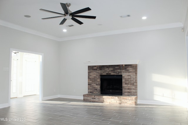 unfurnished living room with a fireplace, ceiling fan, crown molding, and hardwood / wood-style floors