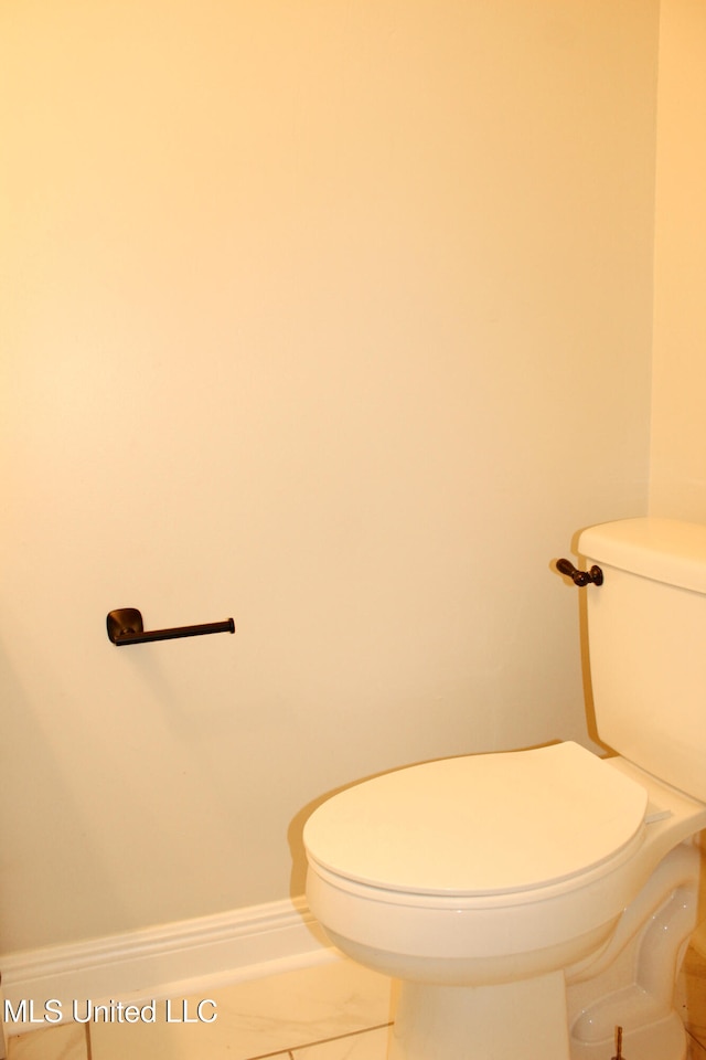 bathroom with tile patterned flooring and toilet