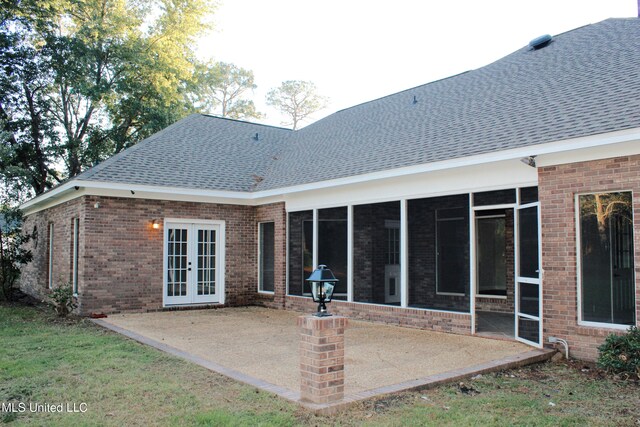 back of property featuring a patio area and a sunroom