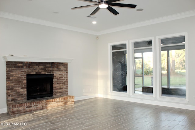 unfurnished living room featuring hardwood / wood-style floors, a brick fireplace, ceiling fan, and ornamental molding