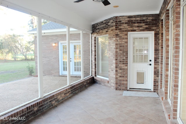 unfurnished sunroom with ceiling fan and a healthy amount of sunlight