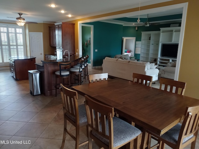 496 Cleveland Crossing Rd, Cleveland, MS 38732 - dining space with ceiling fan, ornamental molding, and light tile patterned floors