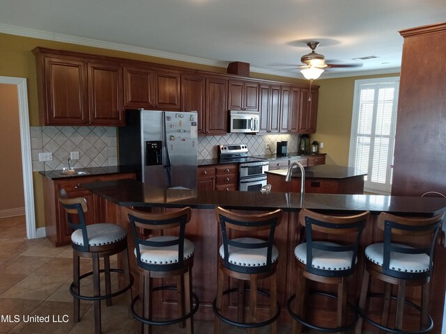 496 Cleveland Crossing Rd, Cleveland, MS 38732 - kitchen with stainless steel appliances, dark countertops, backsplash, and ornamental molding