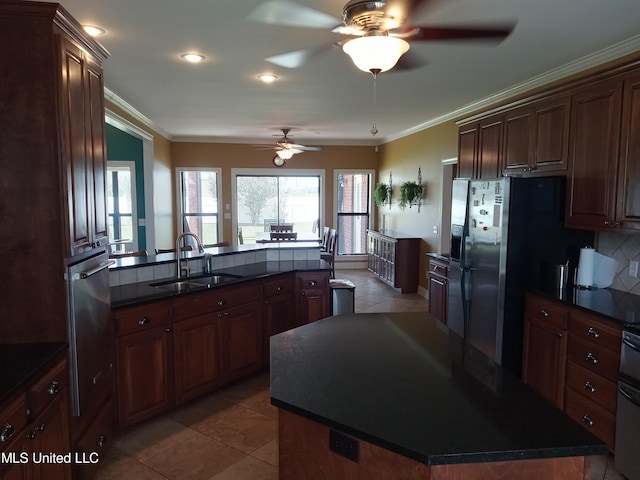 496 Cleveland Crossing Rd, Cleveland, MS 38732 - kitchen with a sink, dark countertops, ceiling fan, crown molding, and tile patterned flooring