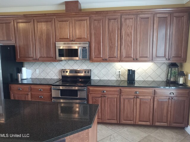496 Cleveland Crossing Rd, Cleveland, MS 38732 - kitchen featuring appliances with stainless steel finishes, dark stone counters, crown molding, backsplash, and brown cabinets