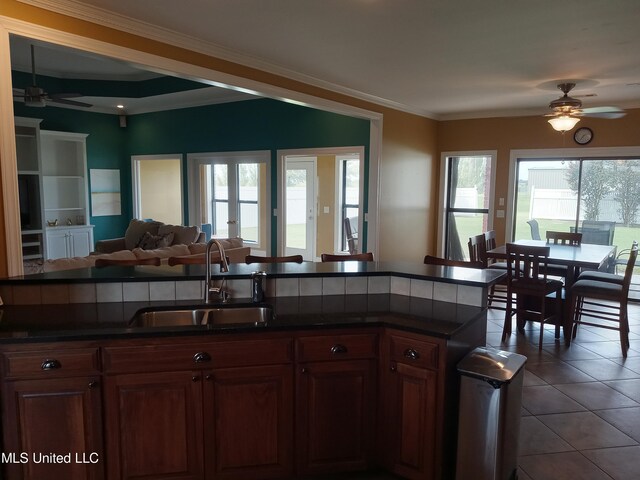 496 Cleveland Crossing Rd, Cleveland, MS 38732 - kitchen featuring ceiling fan, a sink, dark countertops, crown molding, and open floor plan