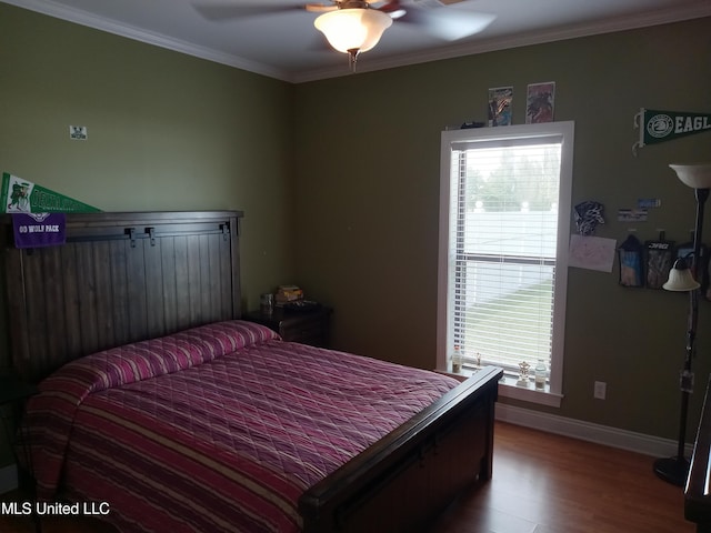 496 Cleveland Crossing Rd, Cleveland, MS 38732 - bedroom featuring multiple windows, wood finished floors, baseboards, ornamental molding, and ceiling fan