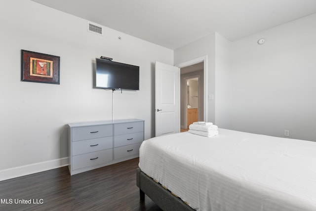 bedroom with dark wood finished floors, baseboards, and visible vents