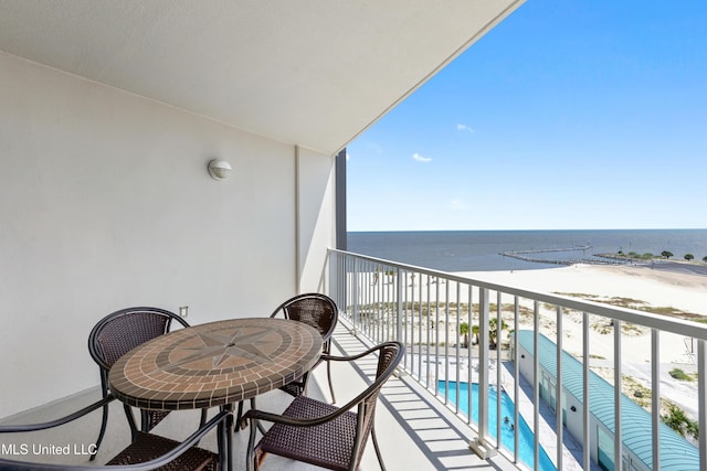 balcony with a beach view and a water view