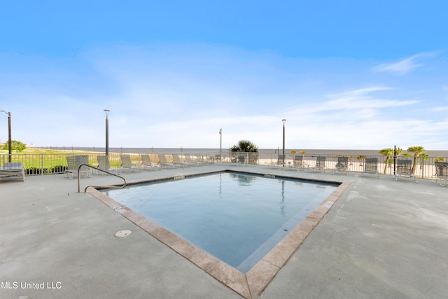 view of pool featuring a patio area and fence