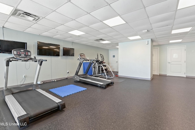 gym featuring visible vents, a paneled ceiling, and baseboards