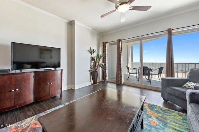 living area with baseboards, dark wood-type flooring, ceiling fan, and ornamental molding