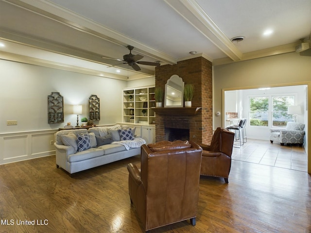 living room with ceiling fan, crown molding, beam ceiling, and wood-type flooring