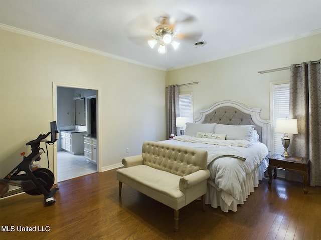 bedroom with ceiling fan, ensuite bath, dark wood-type flooring, and ornamental molding