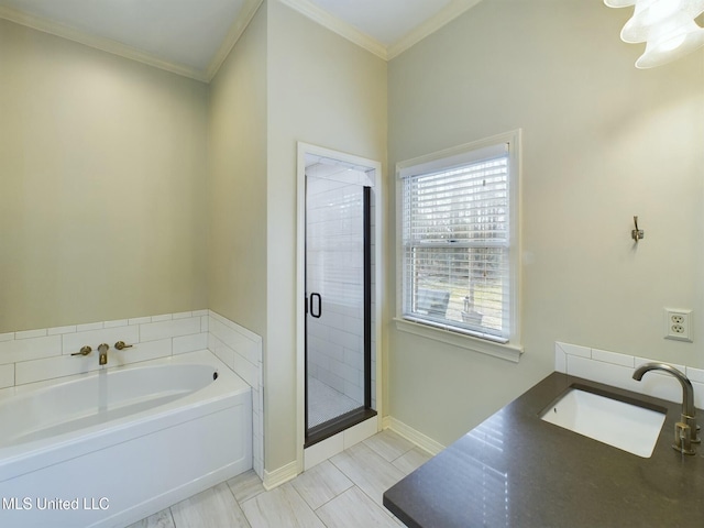 bathroom with independent shower and bath, ornamental molding, and sink