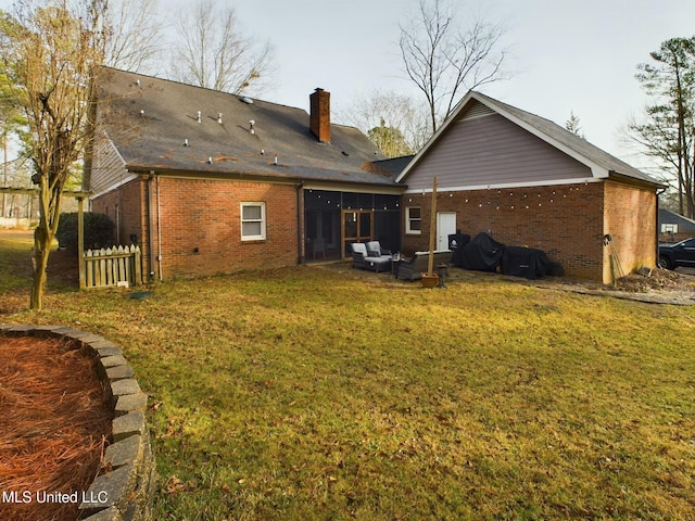 back of property featuring an outdoor living space and a lawn