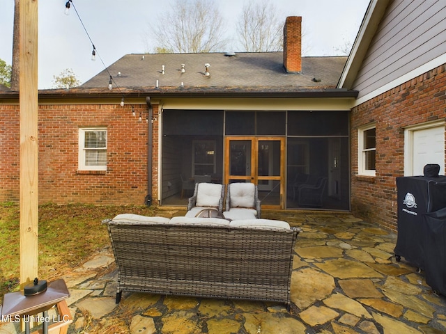 rear view of house with a patio area, outdoor lounge area, and a sunroom