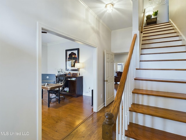 staircase with crown molding and hardwood / wood-style floors